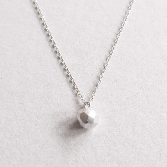 silver facetted ball on necklace